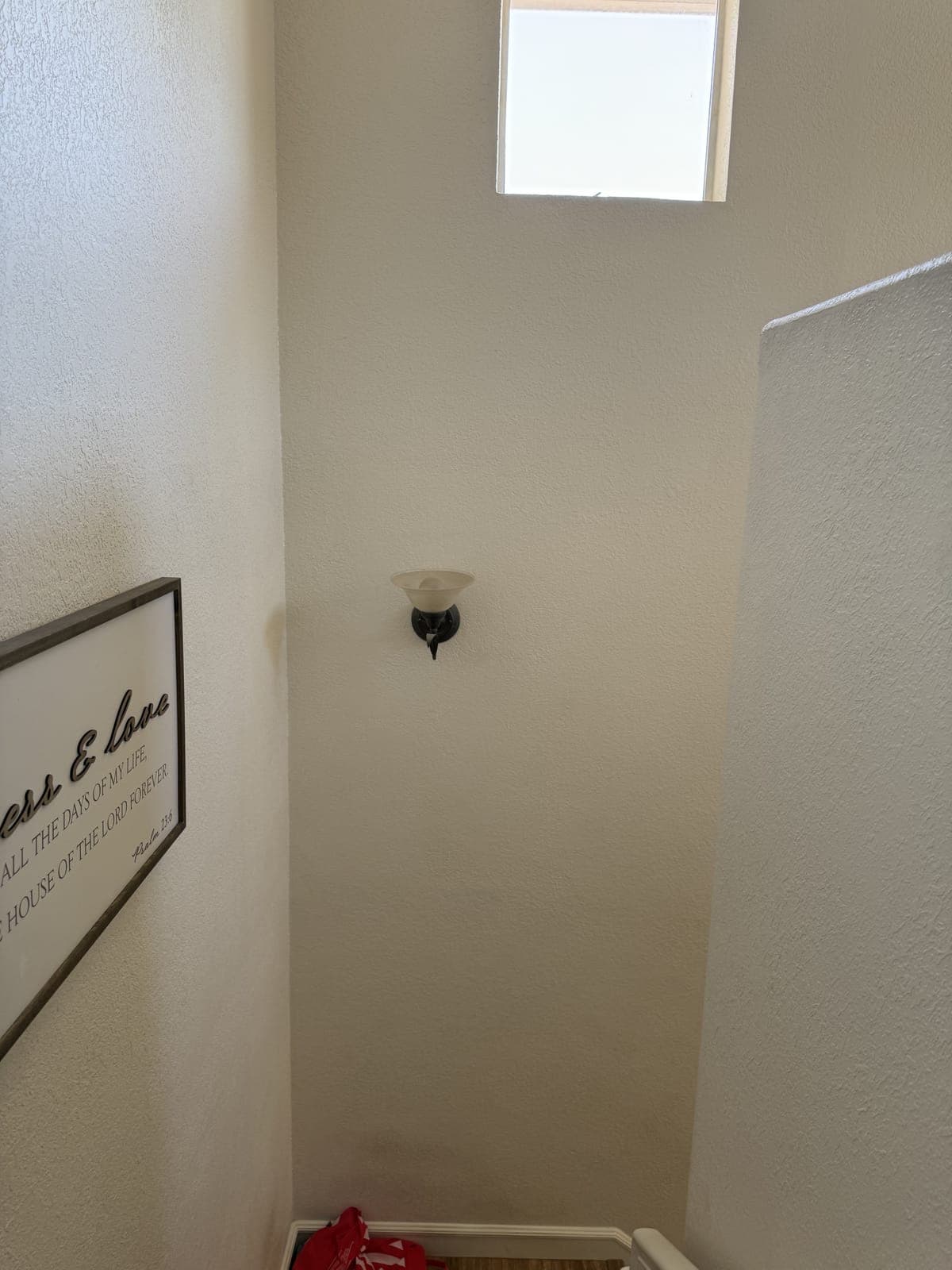 Exterior sconce light before replacement in Campbell