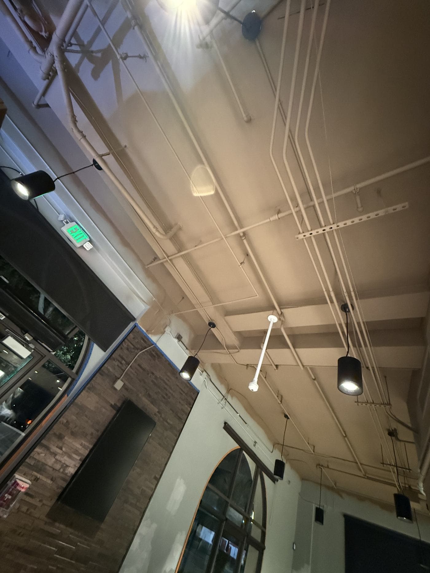 Pendant and track lighting across a high ceiling