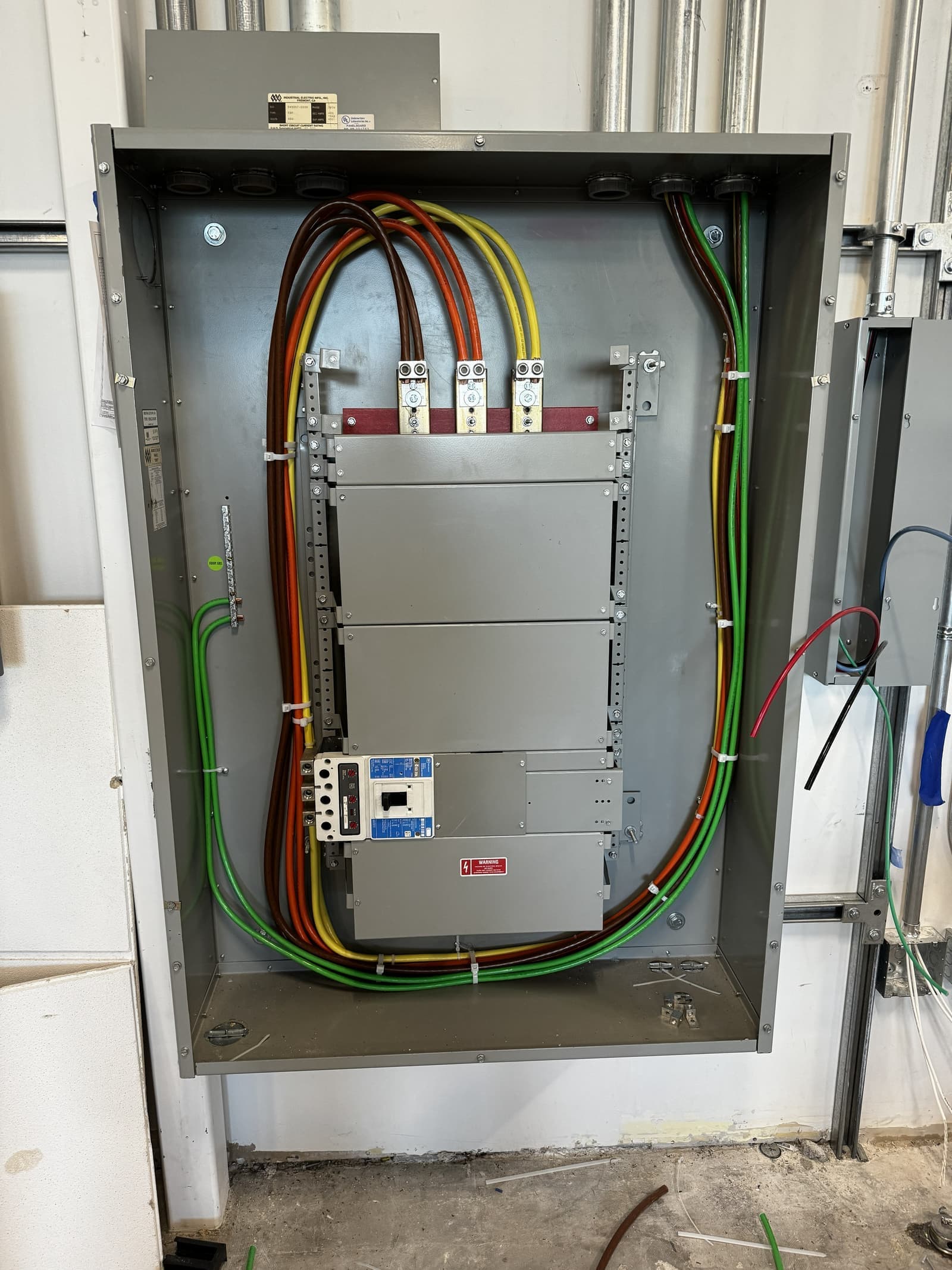 480-volt three-phase distribution gear installed for a Cupertino commercial tenant — Industrial Electric panel, Eaton main breaker, properly terminated phase conductors and full grounding.