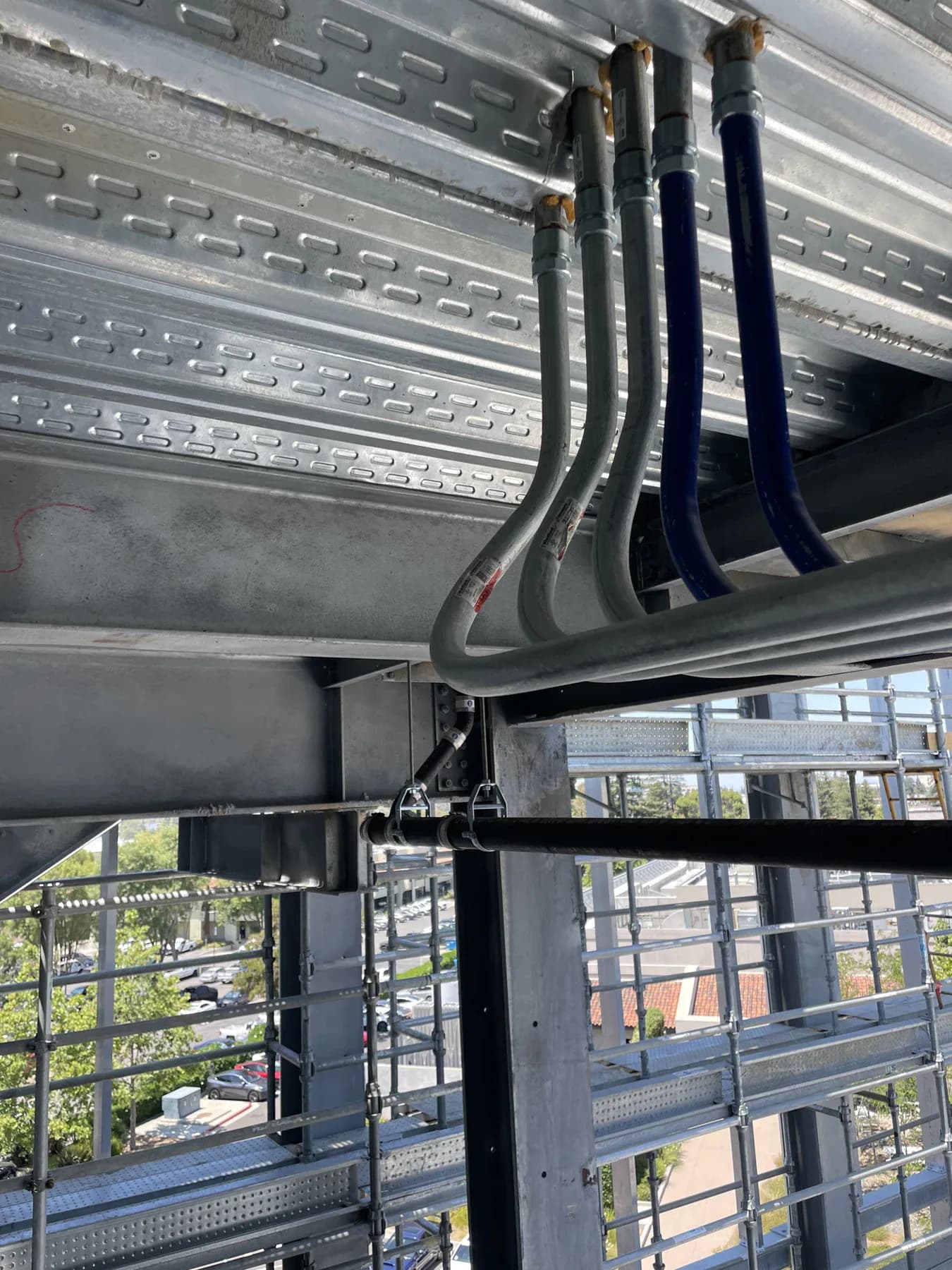 Parallel conduit runs carefully routed through commercial framing