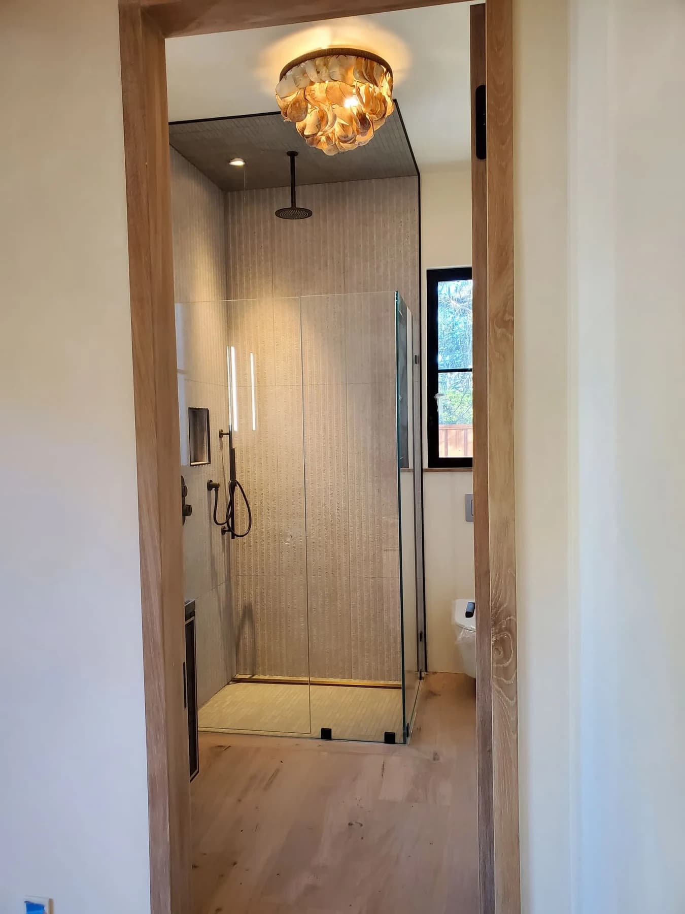 Decorative pendant suspended in a narrow entry hallway