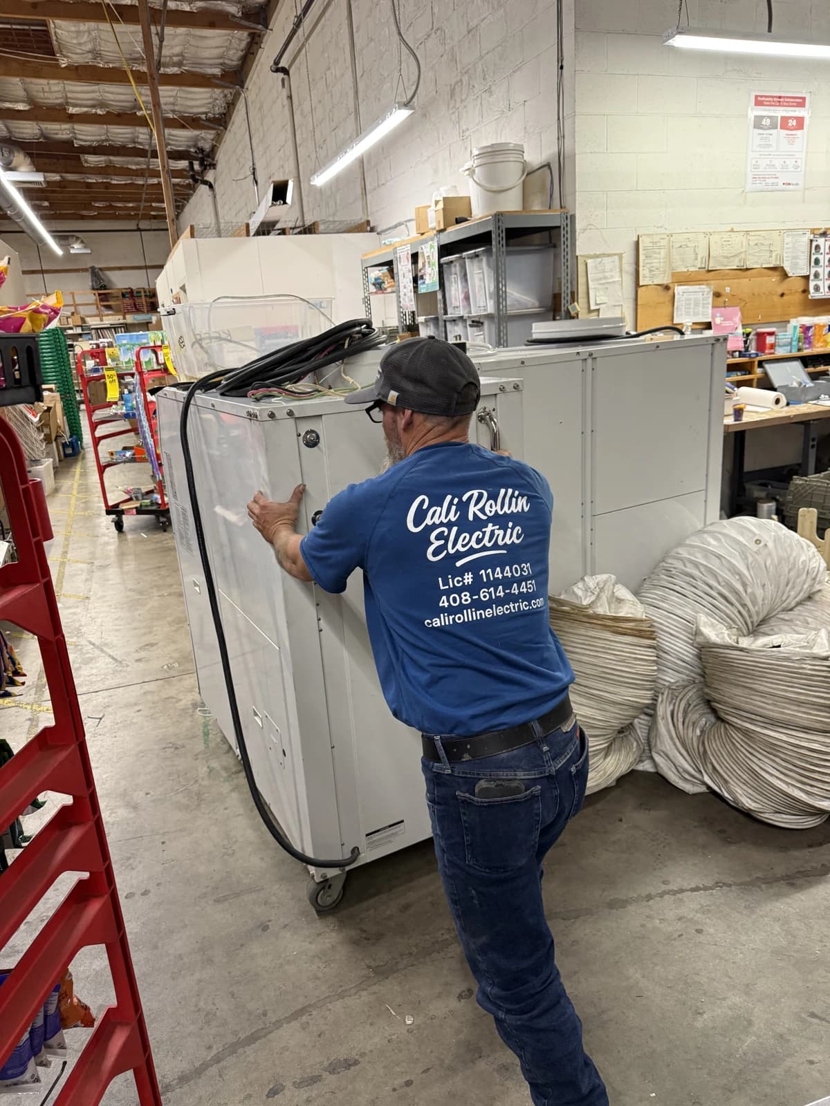 CRE electrician working on equipment inside a commercial facility