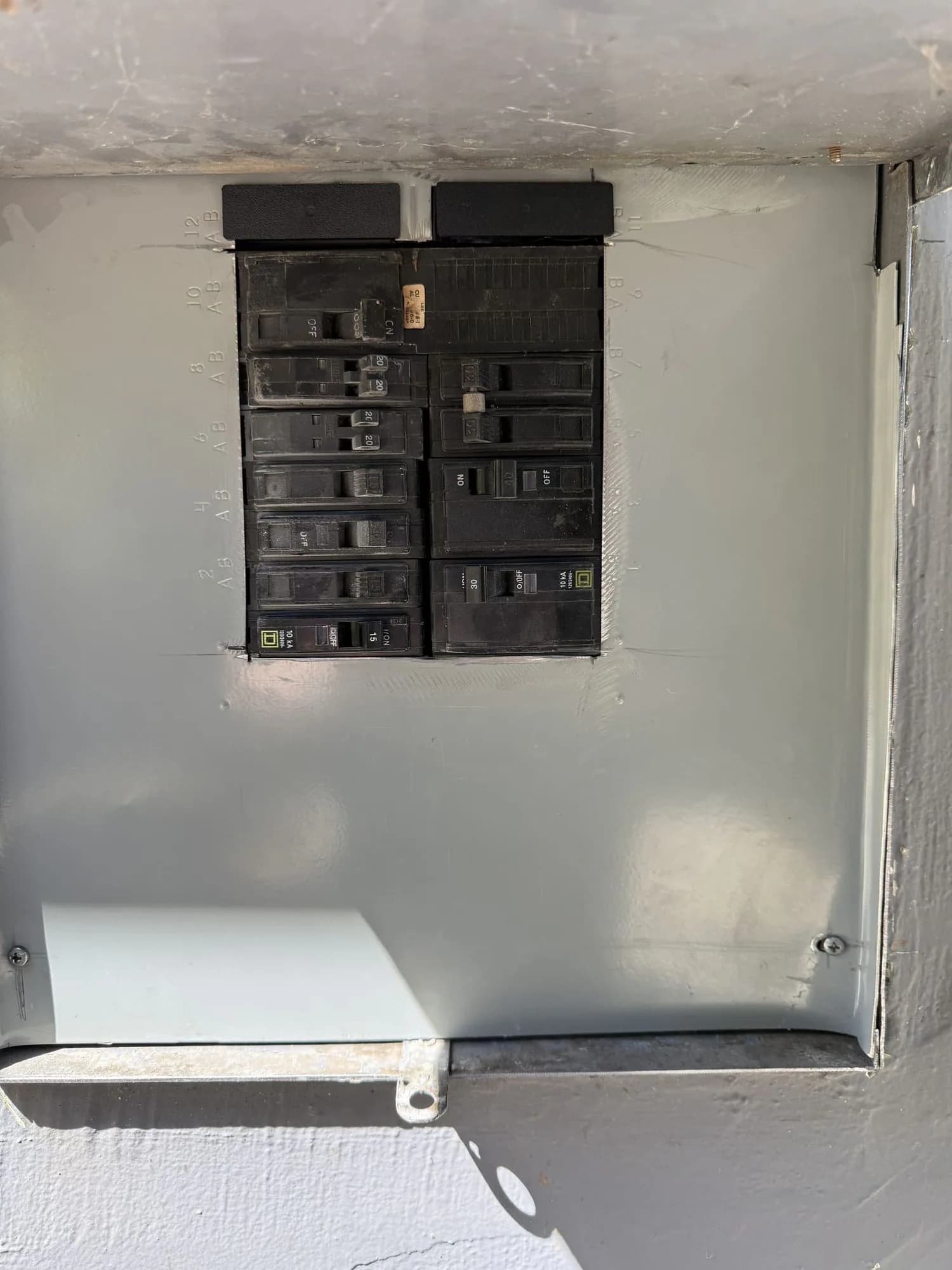 Electrical panel cover and breaker openings