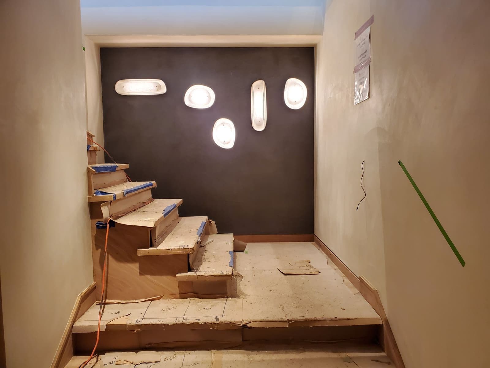 Wall-mounted lights beside a staircase