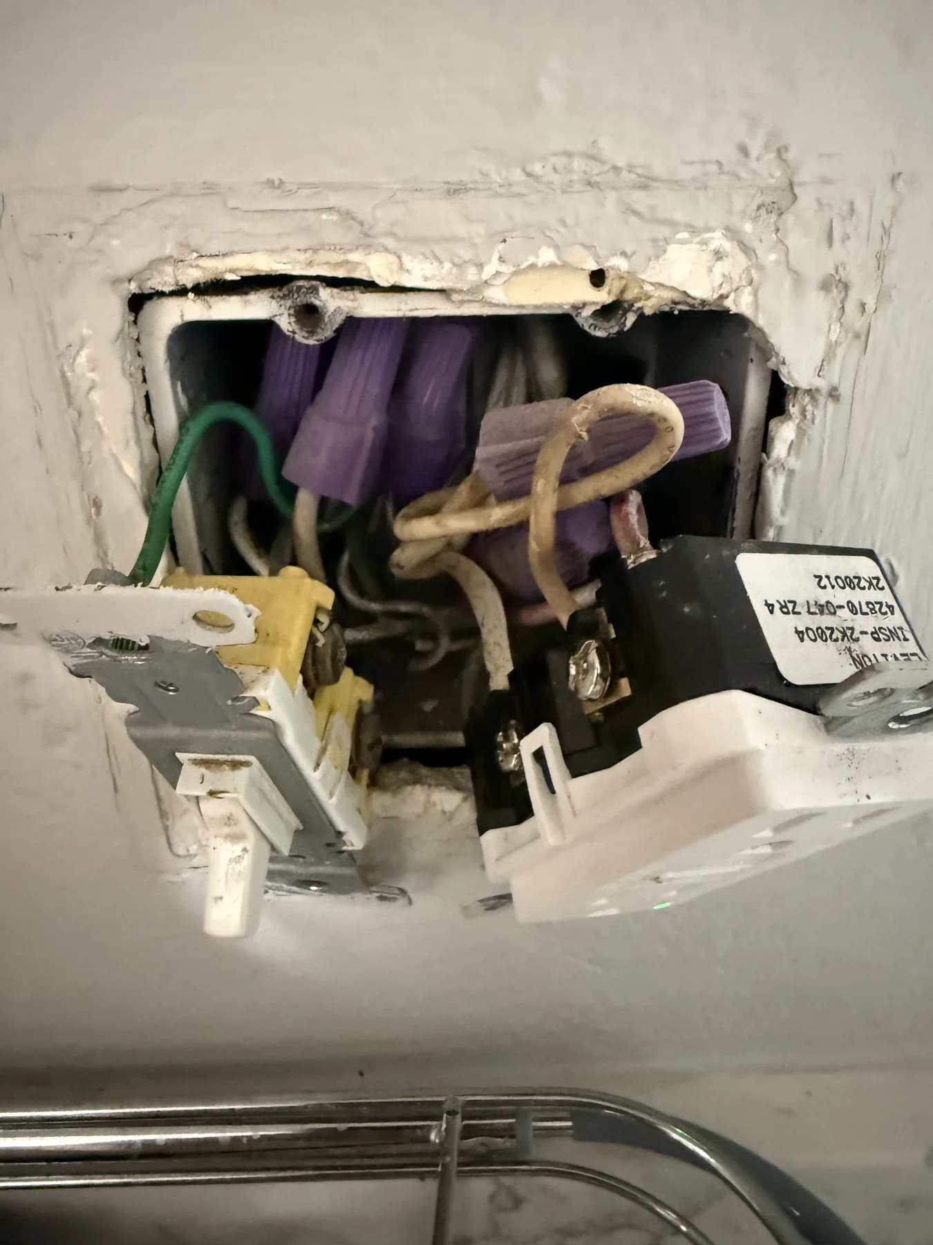 Open switch box with disconnected device and visible conductors