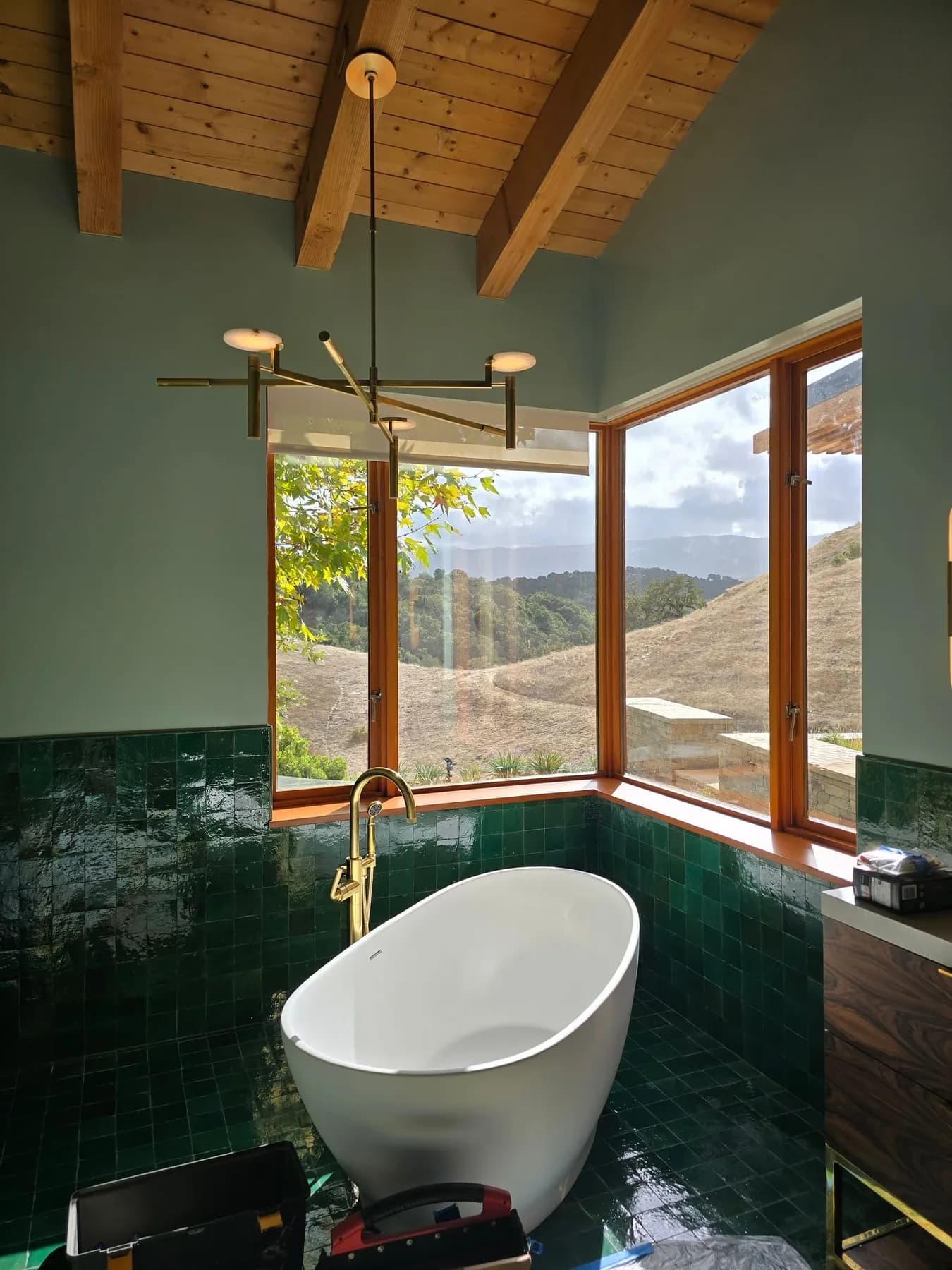 Glowing pendant lights beside a freestanding bathtub