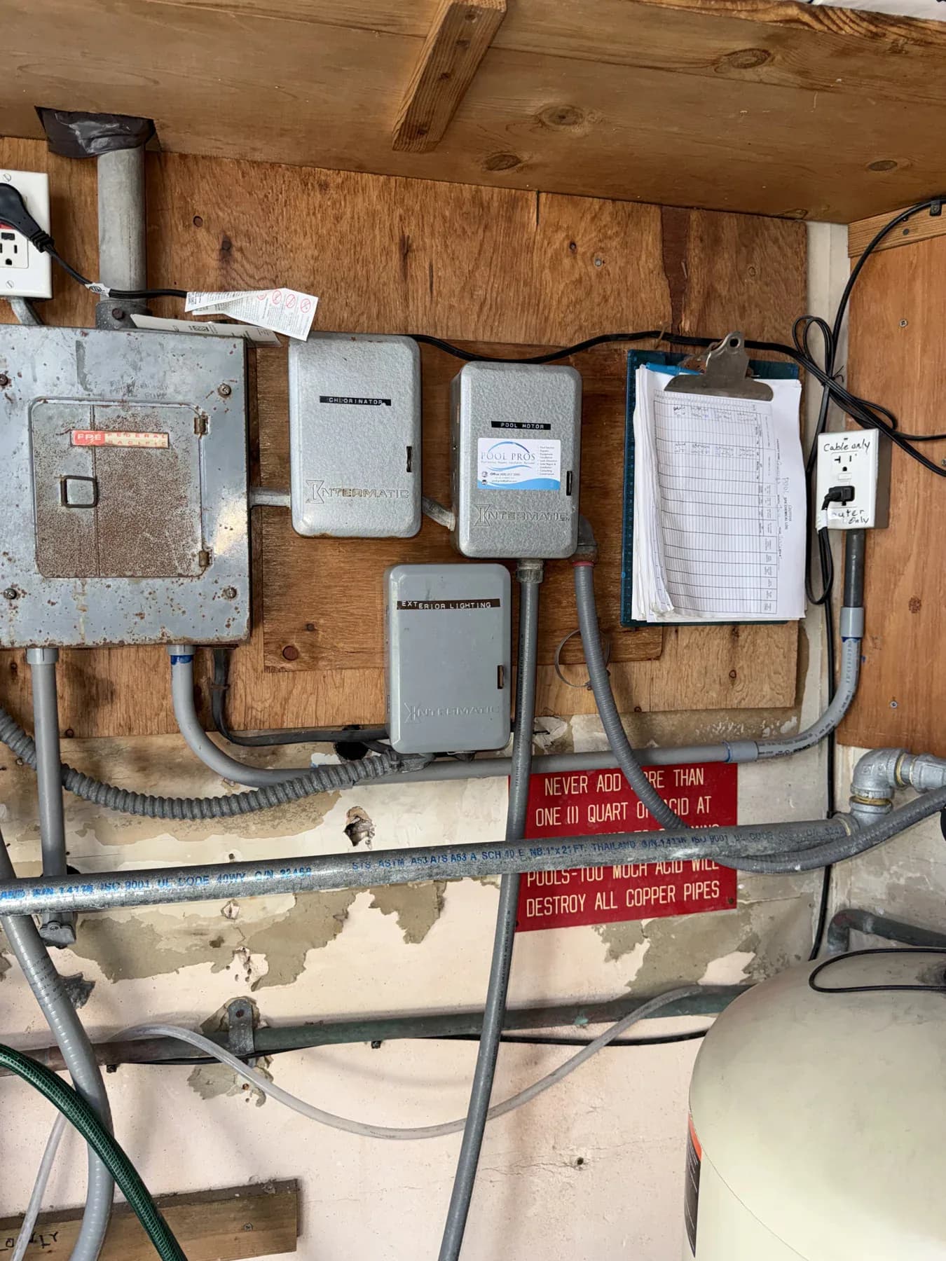 Existing pool-equipment-room enclosures labeled chlorinator, pool motor, and exterior lighting