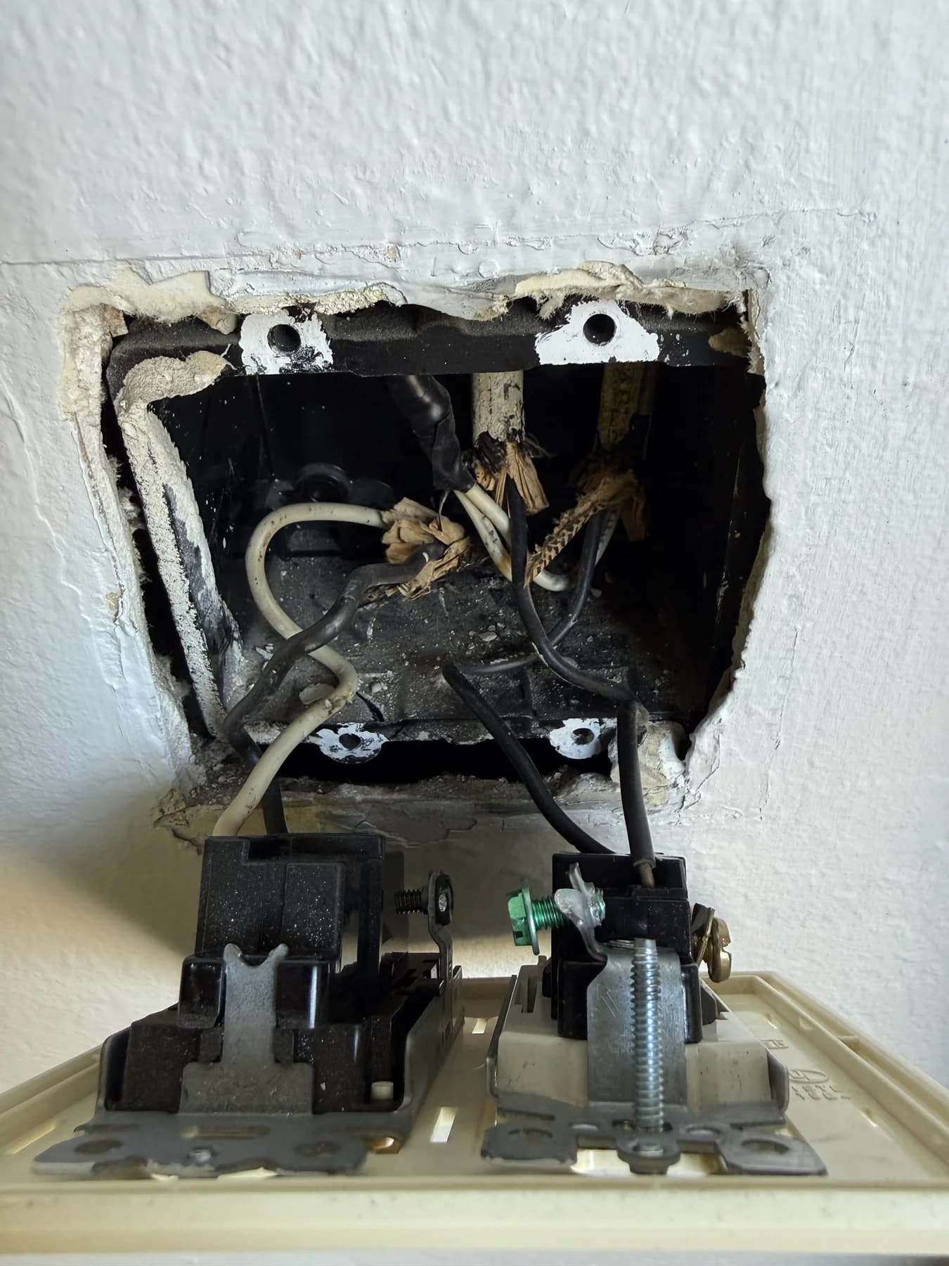 Open switch box with ungrounded conductors and loose connection points
