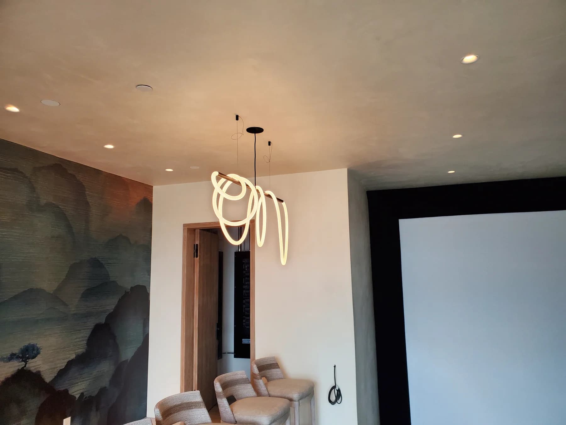 Modern room with a circular pendant and recessed ceiling lights