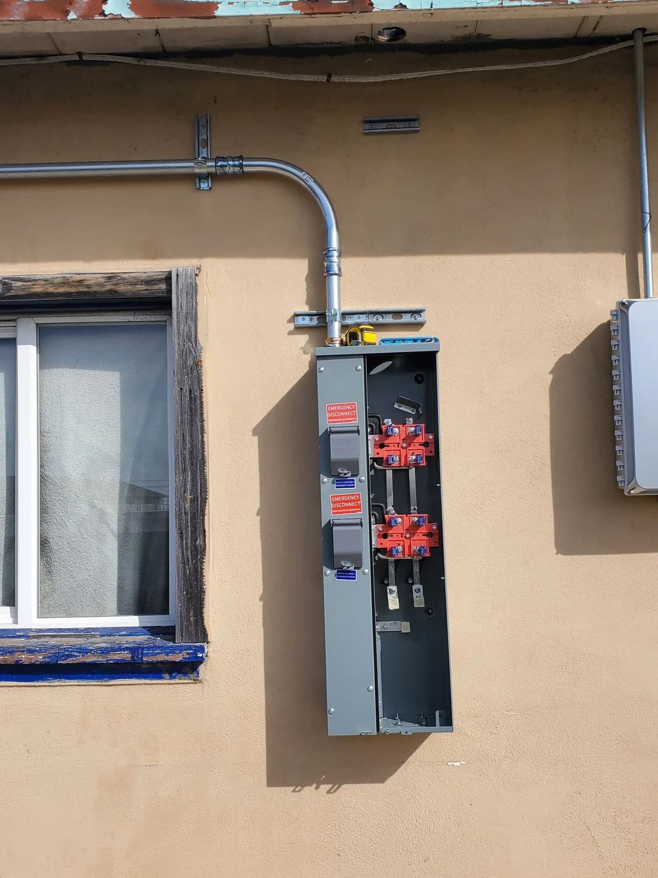 Exterior residential meter and main disconnect equipment under installation