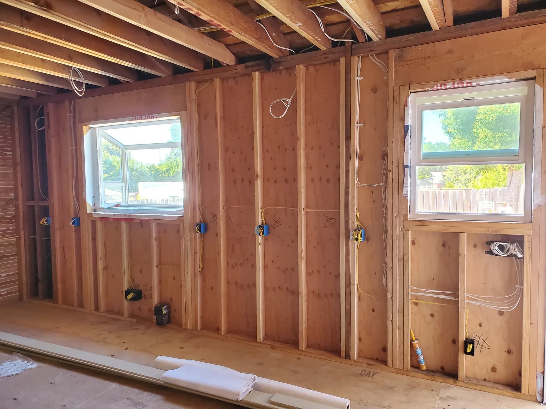 Open residential framing with new electrical boxes and cable routes