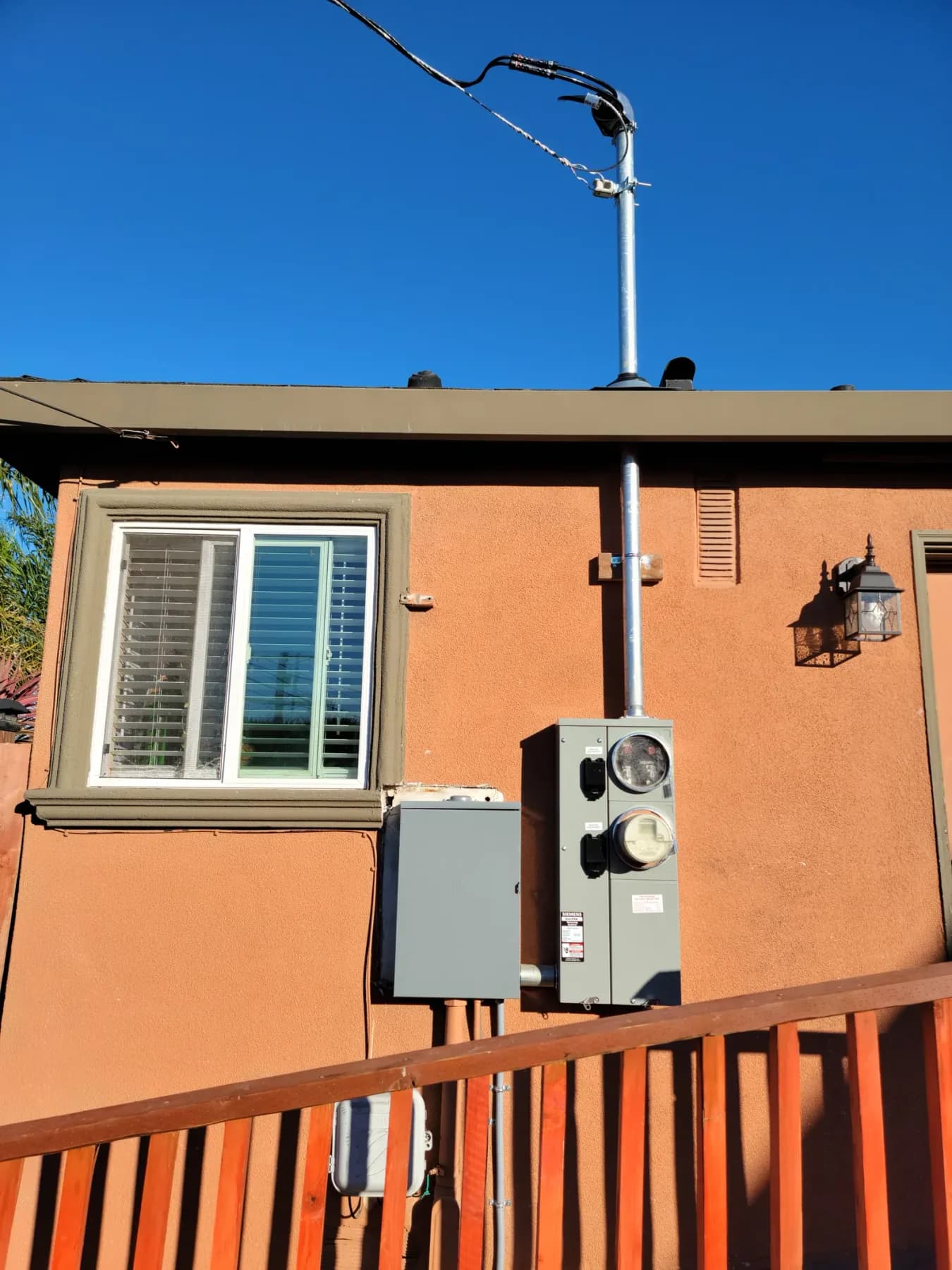 Exterior residential meter-main equipment with a service mast