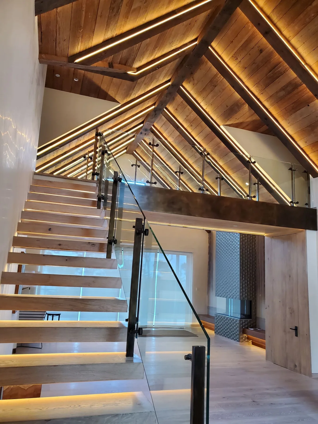 Wood staircase and landing with recessed and decorative lighting