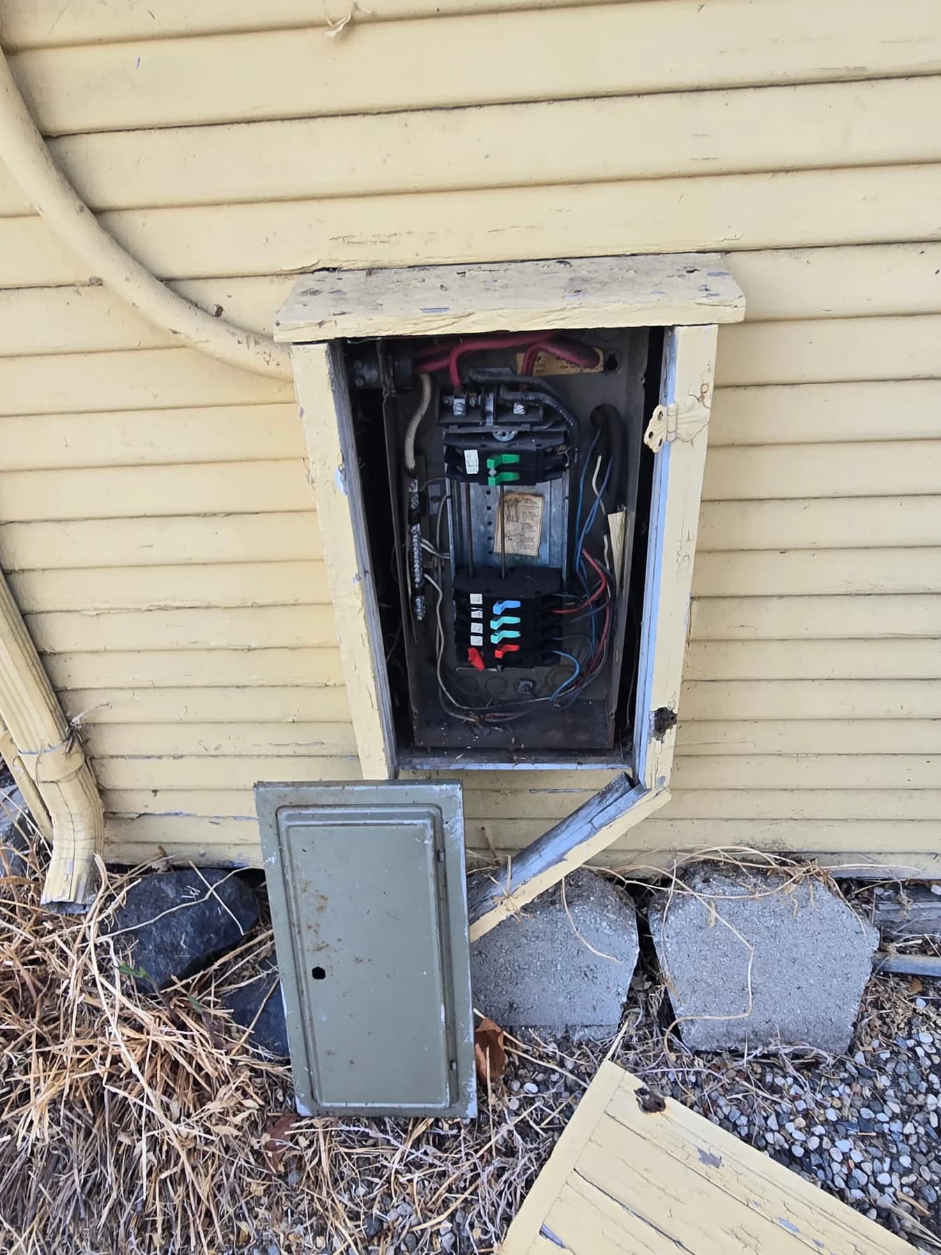 Exterior panel enclosure and utility meter at the same existing installation