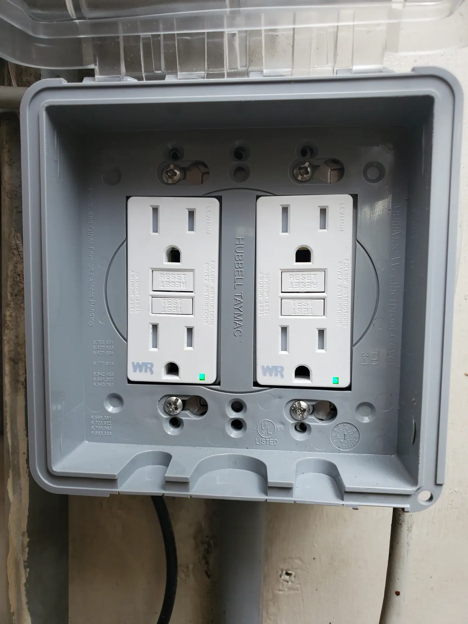 Two GFCI receptacles inside an exterior protective enclosure