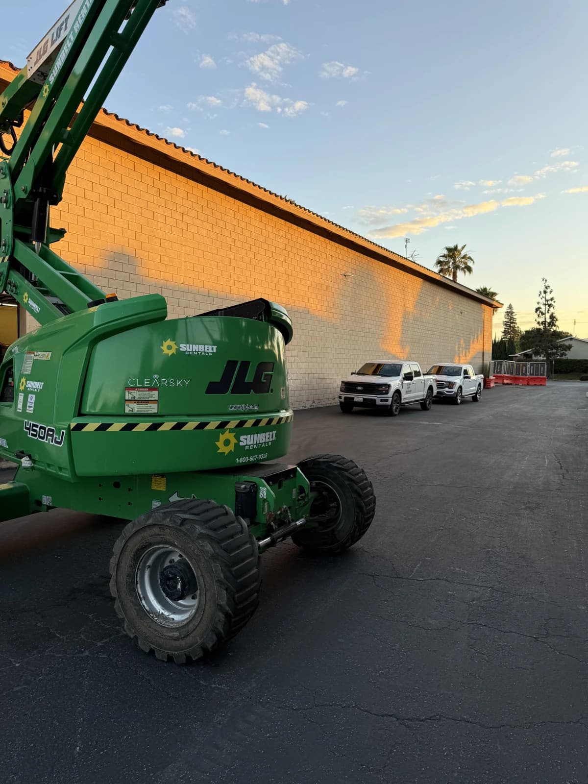 Lift and CRE trucks outside a commercial facility