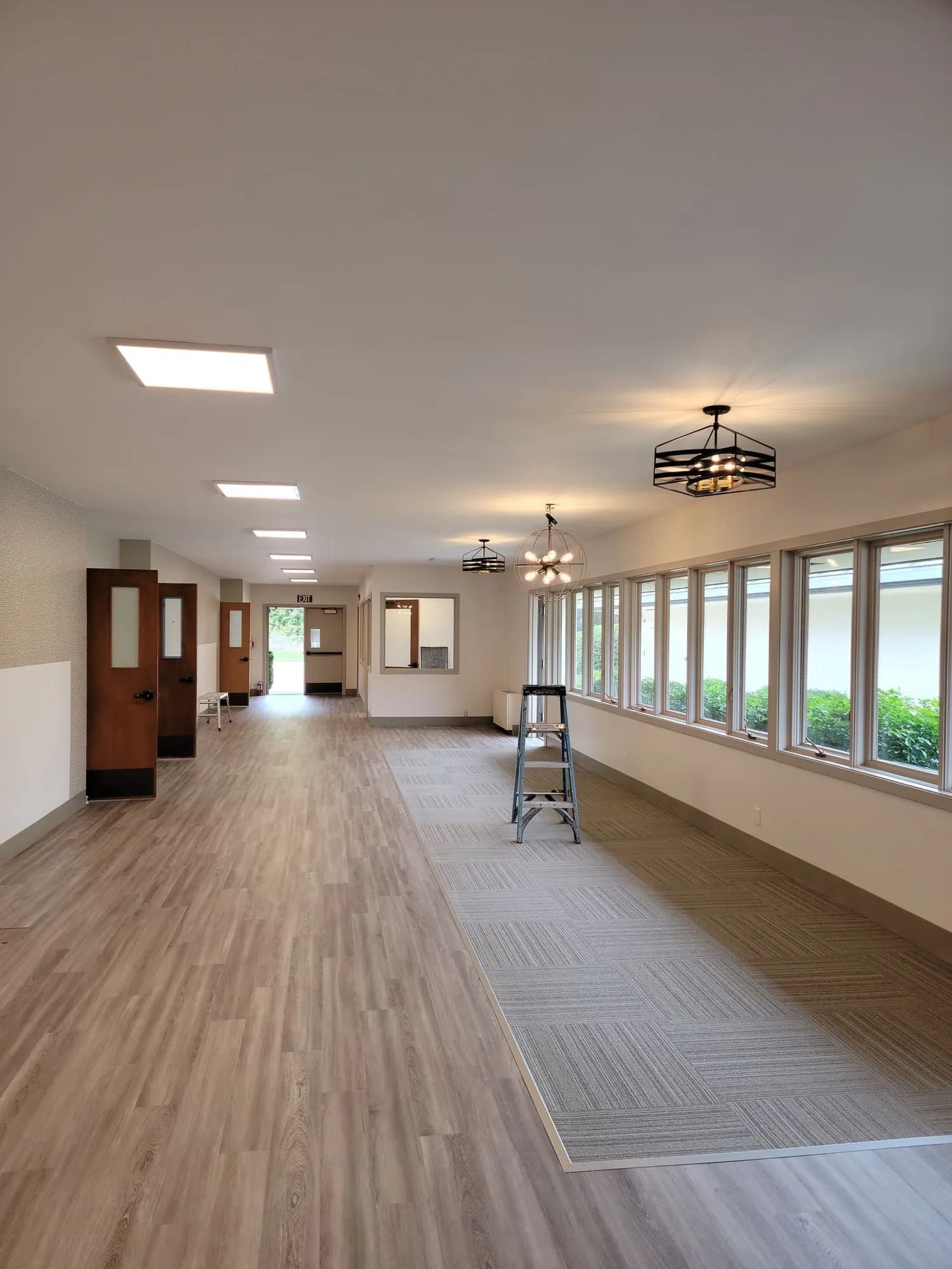 Interior lighting project with aligned ceiling fixtures and pendant lights