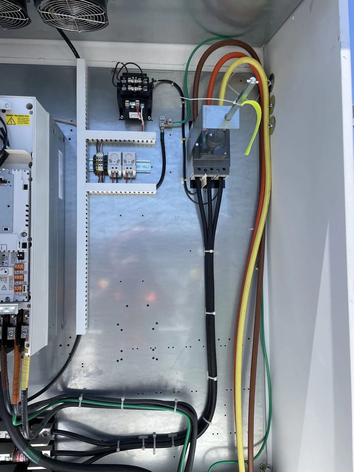 Three-phase conductors and electrical controls inside a project cabinet